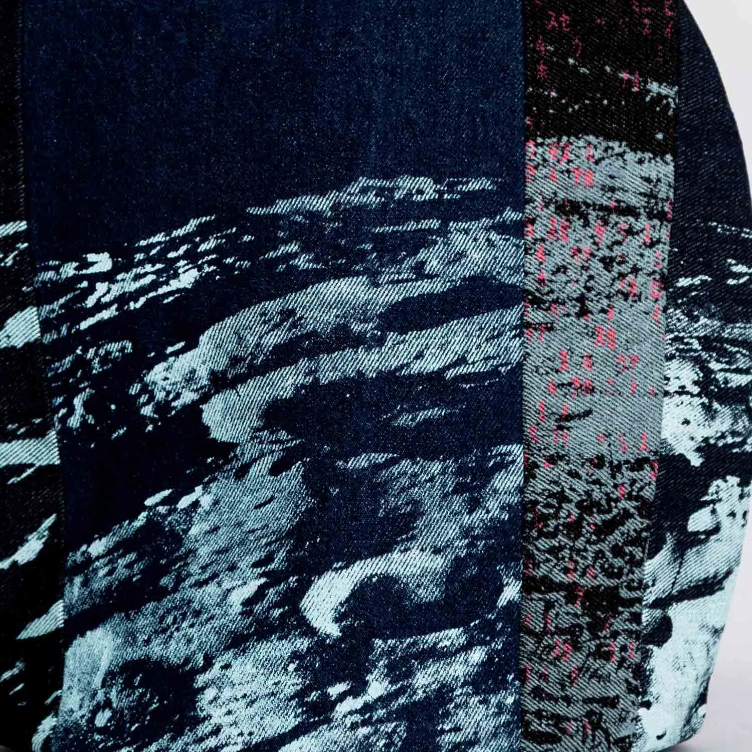 Close-up of tea pot cover, part of MIN-studio’s Space Collection: layered images of the moon’s surface translated into screen-printed designs on durable denim. Printed with blue, grey, and neon pink inks, the multi-layered lunar textures create striking, slightly edgy and grunge-inspired abstract patterns. Designed to fit standard teapots, each denim tea cosy combines functional use with distinctive graphic design.
