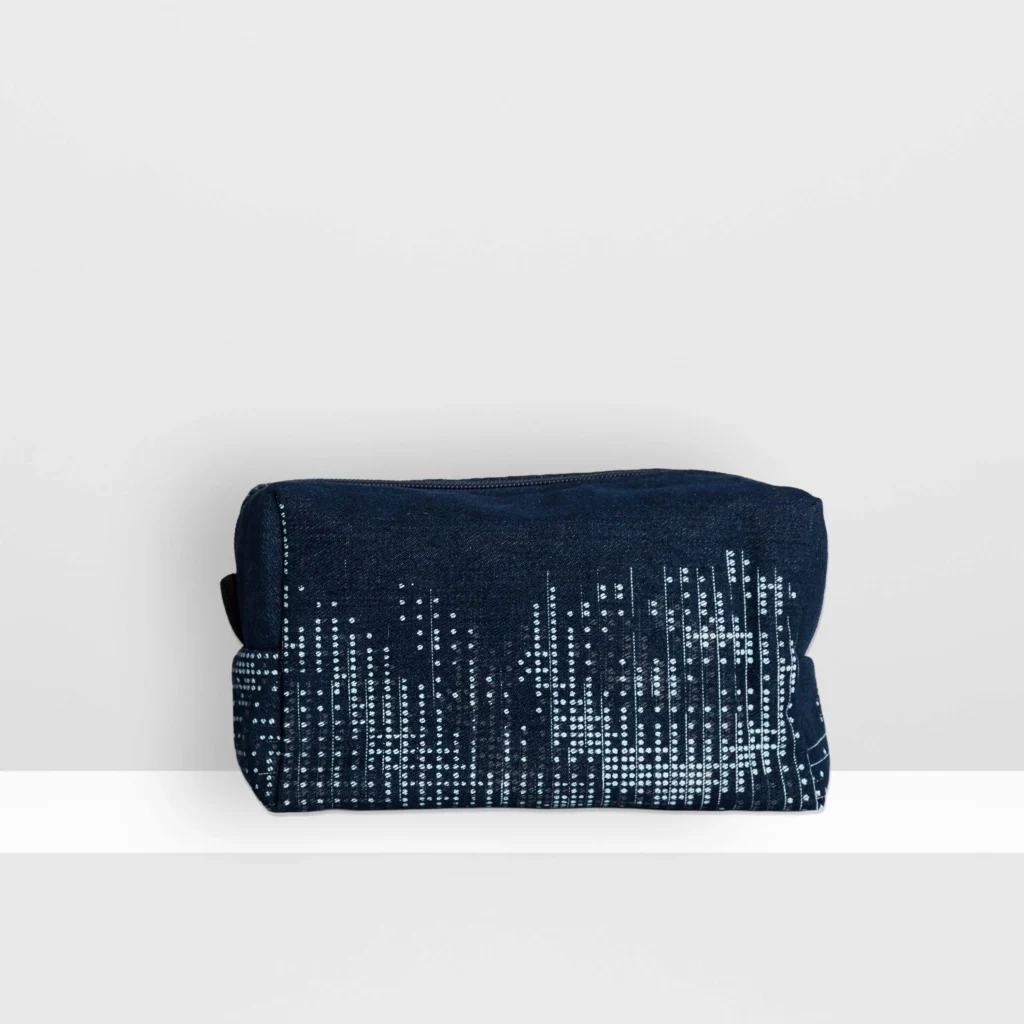 Back view of medium Digital Moss beauty bag showing glow yellow screen-printed moss pattern and patchwork denim construction.