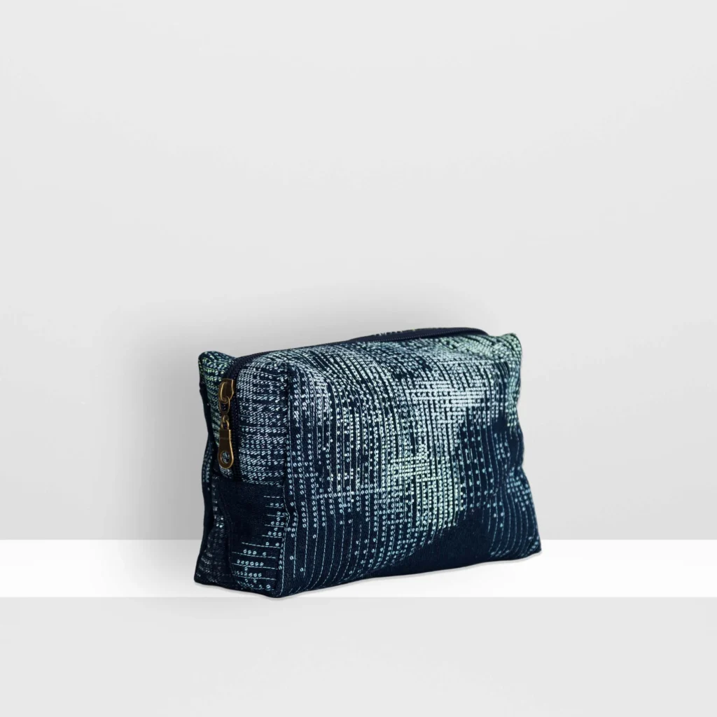 Side view of medium Digital Moss beauty bag showing glow yellow screen-printed moss pattern and patchwork denim construction.