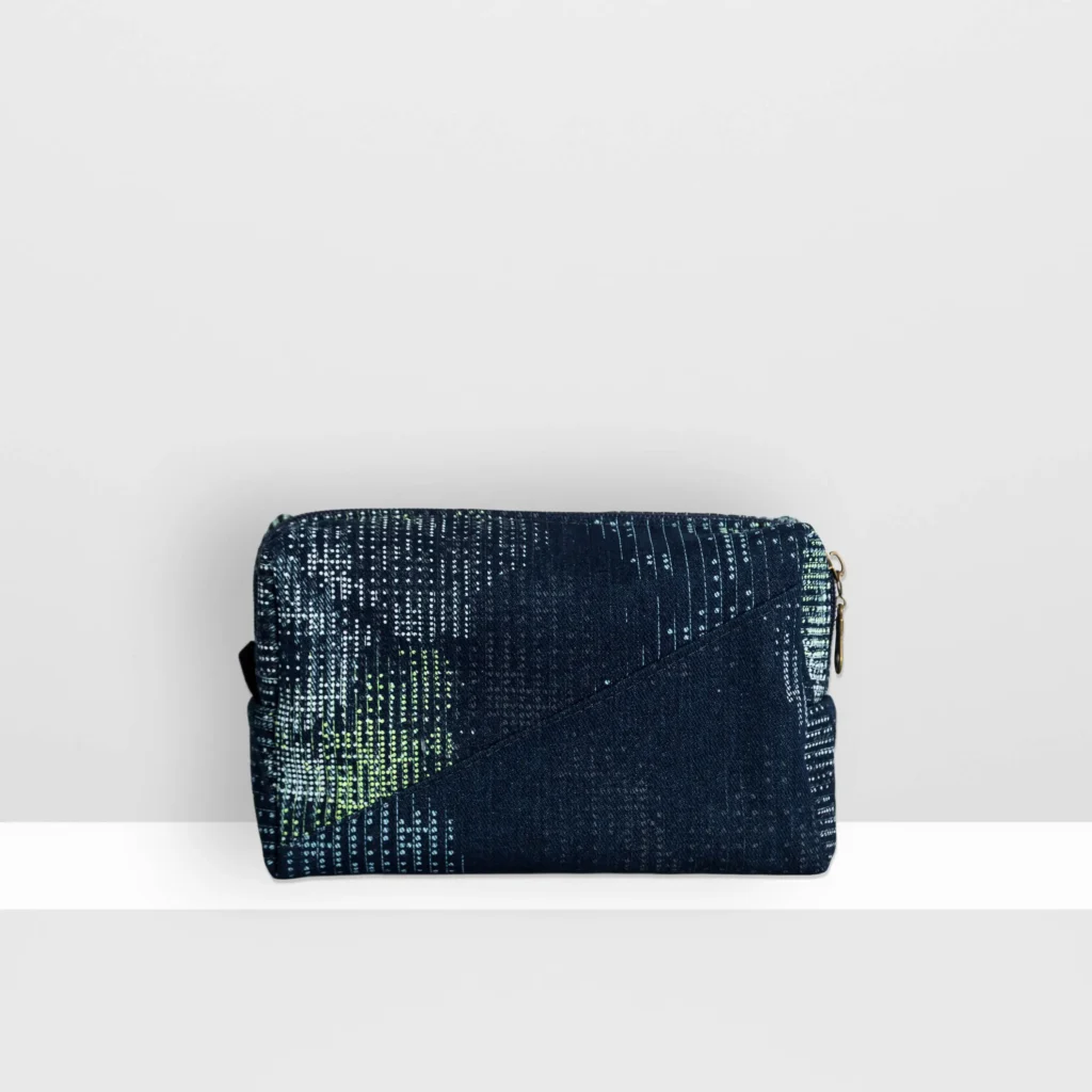 Back view of medium Digital Moss beauty bag showing glow yellow screen-printed moss pattern and patchwork denim construction.