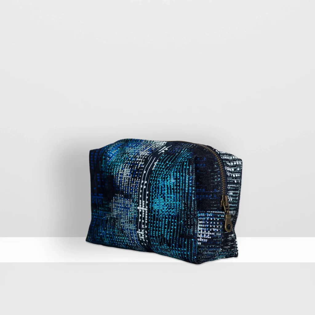 Side view of medium Digital Moss beauty bag with layered blue screen-printed moss pattern on denim by MIN-studio.