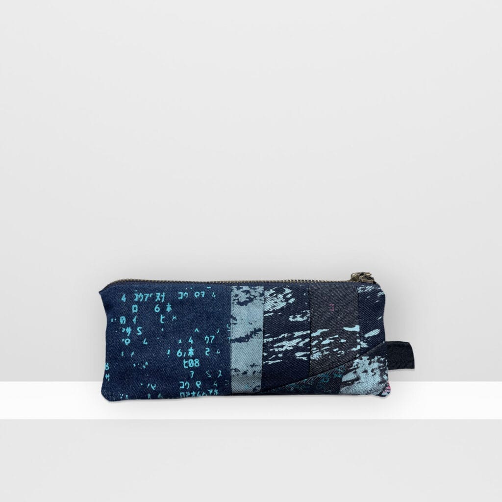 Front view of Space Collection pencil case 1 by MIN-studio, screen-printed denim with layered moon surface landscape design in blue and grey inks.